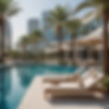 Luxurious pool area at Liv Waterside with sun loungers and palm trees